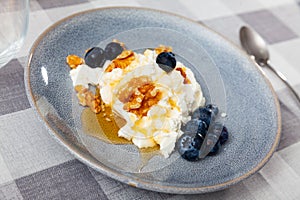 Mato cheese with honey walnuts and blueberries photo