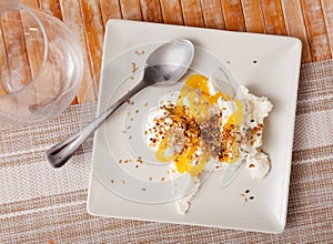 Mato cheese served with honey and sesame seeds photo