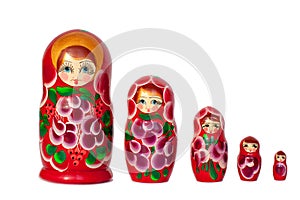 Matreshka Russian doll souvenir bright red, purple and green flowers pattern on white background isolated closeup