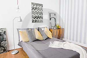 Matrimonial bed with grey bedding