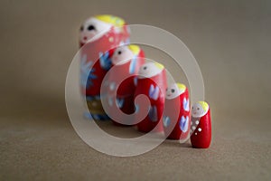 Matryoshka dolls lined up by size with a seamless background photo