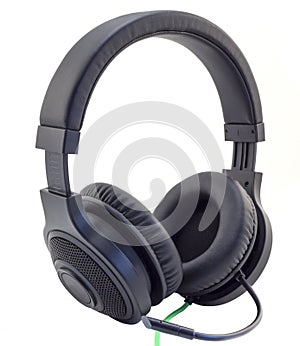 Matt black headphones with a headset with a green wire cuted isolated photo