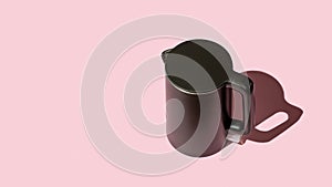 Matte black kettle casts shadow on a pink background. Stylish kitchen appliance for heating water to boiling for tea and coffee.