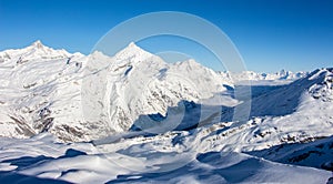 Matter valley and snowy mountains sunset view winter landscape Swiss Alps light clouds in the valley