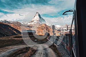 Matterhorn mountain with train running through on sunny day at Riffelboden, Zermatt, Switzerland