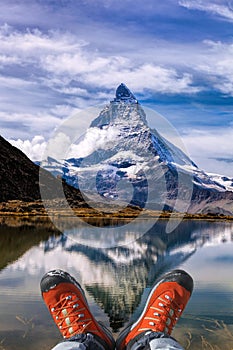 Matterhorn peak with hiking boots in Swiss Alps.