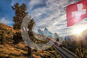 Matterhorn peak with railway against sunset in Swiss Alps, Switzerland