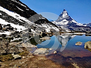 Matterhorn Peak reflection in summer at Riffelsee lake, Gornergrat station, Zermatt, Switzerland