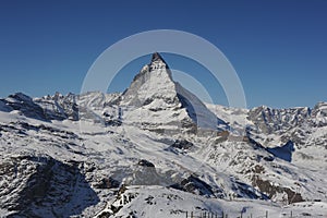 Matterhorn peak in Zermatt in winter with snow and blue sky on a sunny day in the Alps, Switzerland