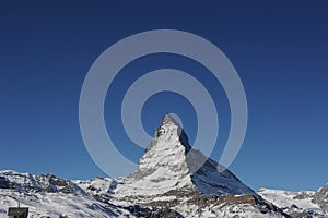 Matterhorn peak in Zermatt in winter with snow and blue sky on a sunny day in the Alps, Switzerland