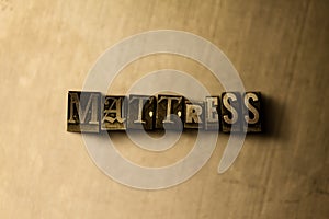 MATTRESS - close-up of grungy vintage typeset word on metal backdrop