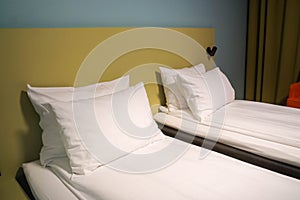 Mattress and comfortable pillows in hotel twin bedroom