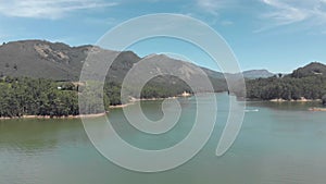 Mattupetty Lake beautiful scenery amidst mountainous valley in Munnar, India - Aerial Low angle Panoramic shot