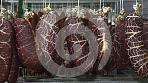 Maturation of smoked sausages on the shelves of the meat processing plant . The traditional method of maturing sausages