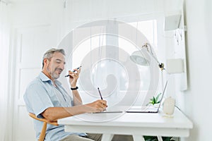 Mature adult man using voice recognition on mobile phone, Speaker Phone