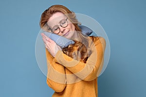 Mature adult woman with neck pillow resting and sleeping comfortable.
