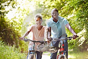 Mature African American Couple On Cycle Ride In Countryside