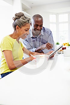 Mature African American Couple Using Digital Table