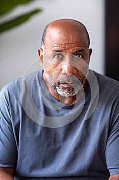 Mature African American man with a serious look on his face.