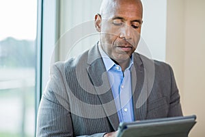 Mature African American man working on a tablet.