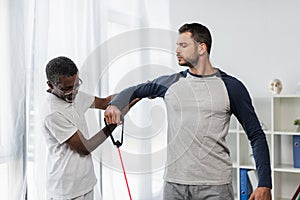 mature african american trainer helping young