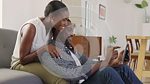 Mature african man and beautiful woman browsing on digital tablet