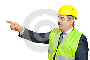 Mature architect man pointing to copy