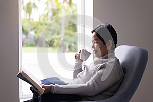 Mature asian woman drinking coffee at home in the morning,Happy and smiling,Positive thinking,Health care senior insurance concept