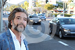 Mature attractive man waiting at the street