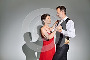 Mature attractive smiling couple dancing ballroom