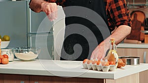 Mature baker using flour