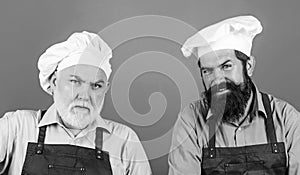 Mature bearded chef. tired of cooking. masters of kitchen. family dinner. father and son cooking together. commercial