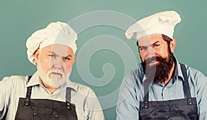 mature bearded chef. tired of cooking. masters of kitchen. family dinner. father and son cooking together. commercial