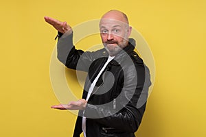 Mature bearded man bragging about the big size of something. photo