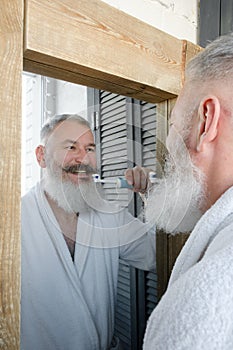 Mature bearded man brushing teeth, dental hygiene concept, morning routine, slow motion