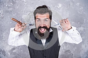 mature bearded man hipster in hairdresser salon with tools of vintage razor and scissors, hairstyle.