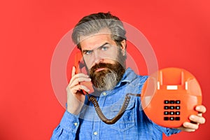 Mature bearded man talk on retro phone. vintage technology in modern life. young man talking on telephone. senior man