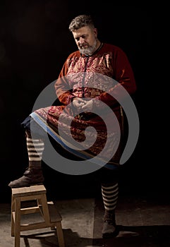 Mature bearded man in traditional historic clothes