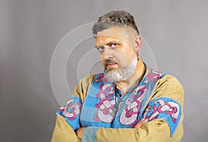 Mature bearded man in traditional historic clothes