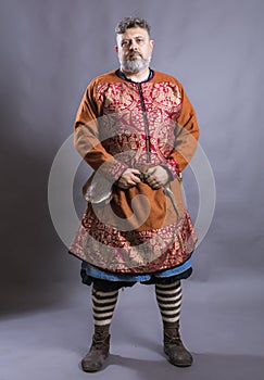 Mature bearded man in traditional historic clothes