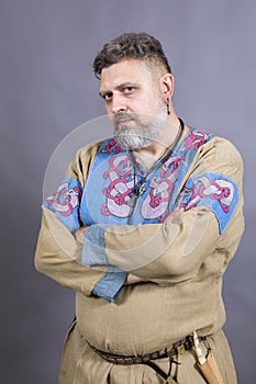 Mature bearded man in traditional historic clothes