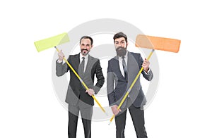 mature bearded men in formal suit hold householding mop. clean slate. Partnership and teamwork. businessmen clear wall