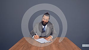 Mature beardy businessman in grey suit