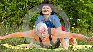 Mature beautiful couple in love on a gren lawn