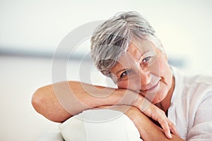 Mature beauty. Closeup of lovely mature woman smiling while relaxing at home.