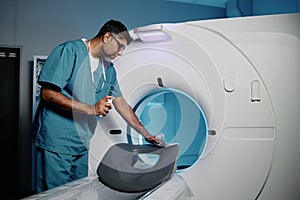 Radiographer Cleaning CT Scanner photo