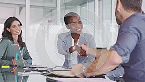 Mature black businesswoman shaking hands with new business partner