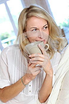 Mature blond woman with cup of tea