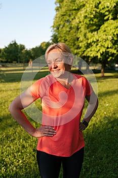 Mature blonde woman portrait in park on sunset summer day