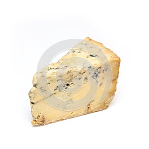 Mature blue Stilton cheese isolated on a white studio background